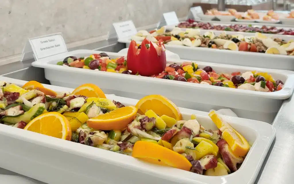 Sea Cloud Spirit Lido Bistro buffet spread featuring octopus and citrus salad, Greek salad with a carved tomato, Niçoise and smoked salmon