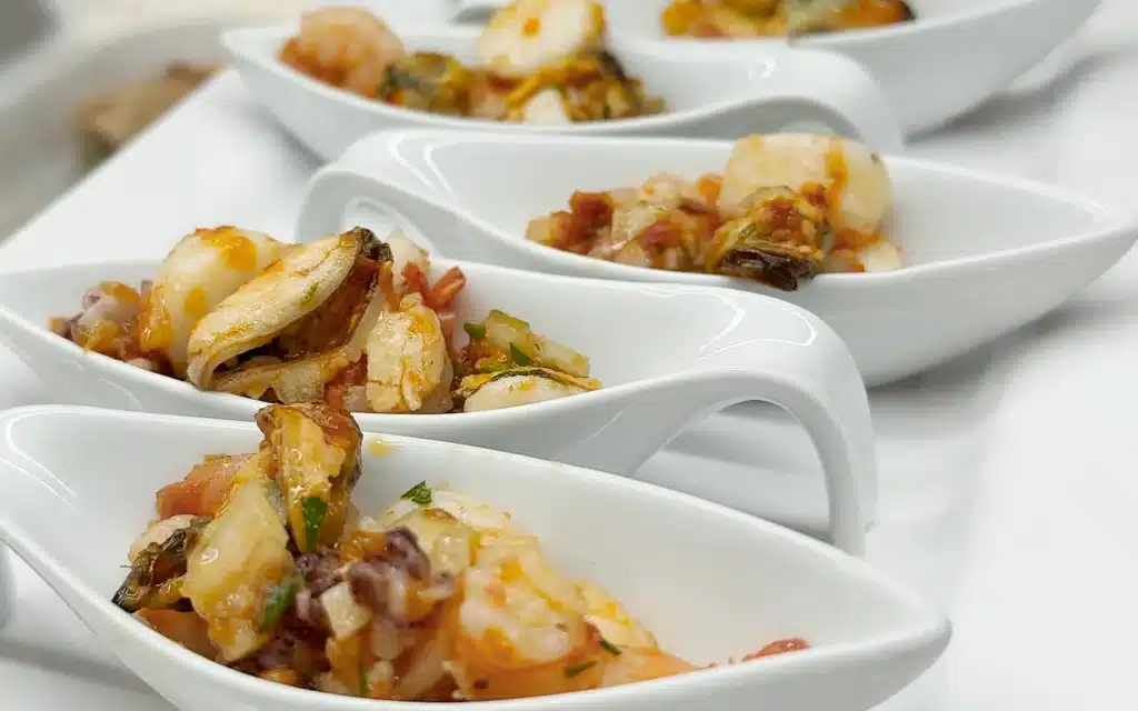 Sea Cloud Spirit Lido Bistro seafood amuse-bouche served in white porcelain spoons with prawn, mussel and tomato salsa