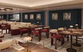 The interior dining room of Beefbar restaurant on Crystal Grace, featuring deep teal walls, burgundy upholstered chairs, cream curved banquettes, dark wood tables with ambient table lamps, and abstract artwork
