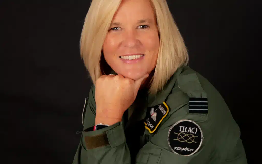 Mary Hickson smiling confidently in a Tornado squadron military flight suit