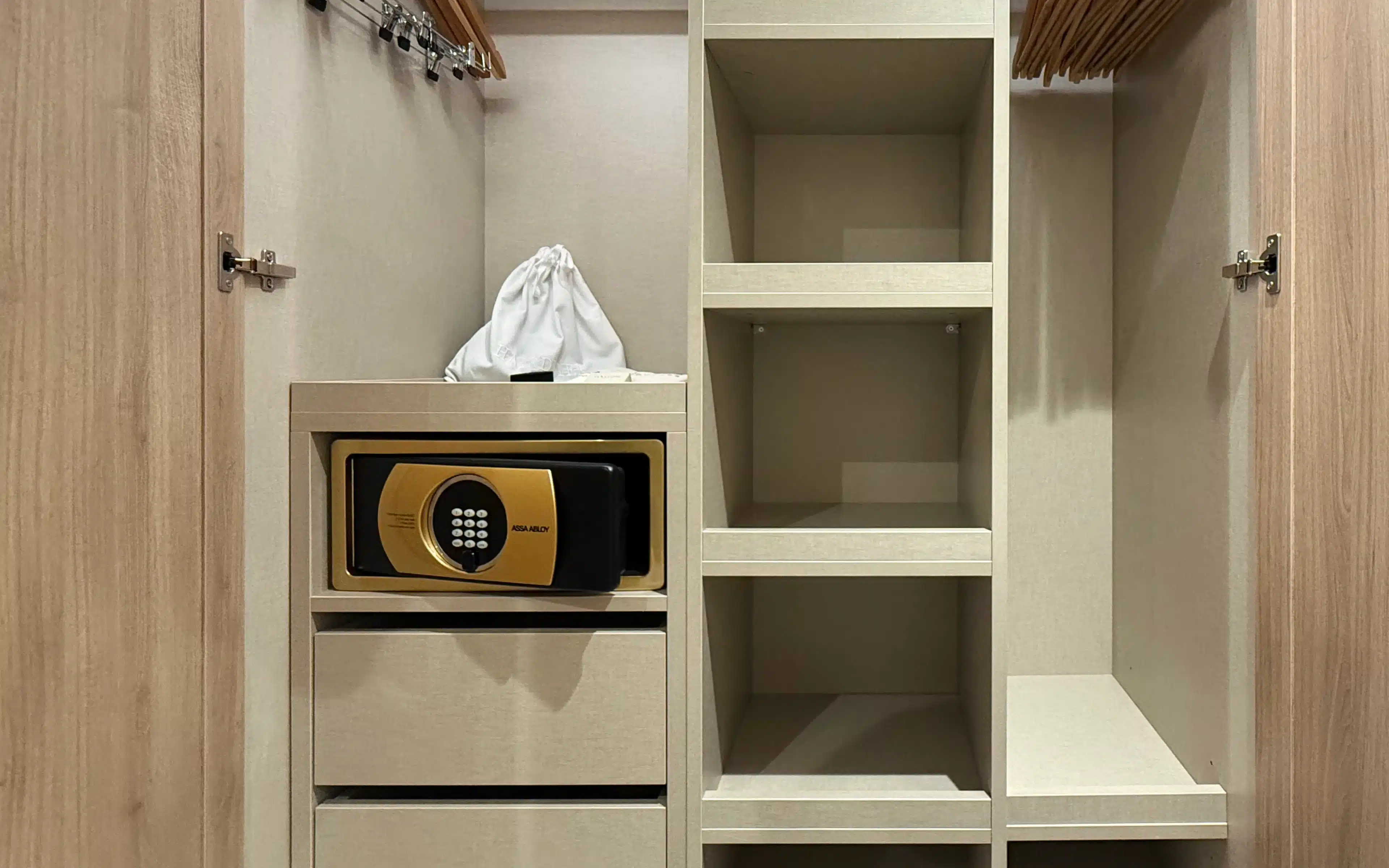 World Voyager Veranda and Horizon Suite wardrobe with dual hanging rails, open shelving, built-in drawers, and a gold digital in-room safe