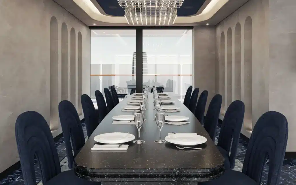 Architectural rendering of the Chef's Table private dining room aboard Explora III, featuring a long dark granite-topped table set for twelve with white plates, folded napkins, and crystal stemware, flanked by navy velvet high-backed chairs, arched relief detailing on stone-clad walls, a large crystal grid chandelier, dark marble tile flooring, and floor-to-ceiling windows overlooking the ship's exterior deck