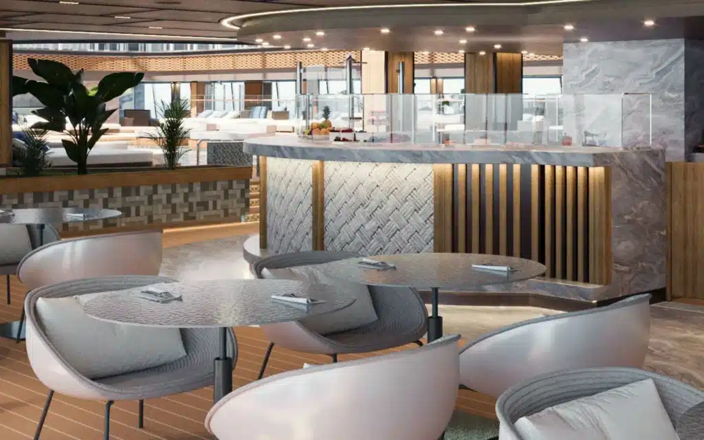 Architectural rendering of the Shore Club indoor-outdoor dining venue aboard Explora III, featuring curved marble-topped bar with woven-panel detailing, warm timber decking, blush-toned bucket chairs at round granite tables, tropical foliage, and a pool terrace visible beyond glass balustrades