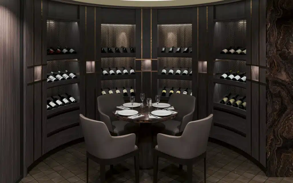 Architectural rendering of The Cellar private dining alcove aboard Explora III, featuring curved dark-stained timber shelving lined with wine bottles and gold mesh niche detailing, a round dark stone pedestal dining table set for four with white plates and crystal stemware, taupe upholstered armchairs, dark tile flooring, and a dramatic veined marble accent panel to the right