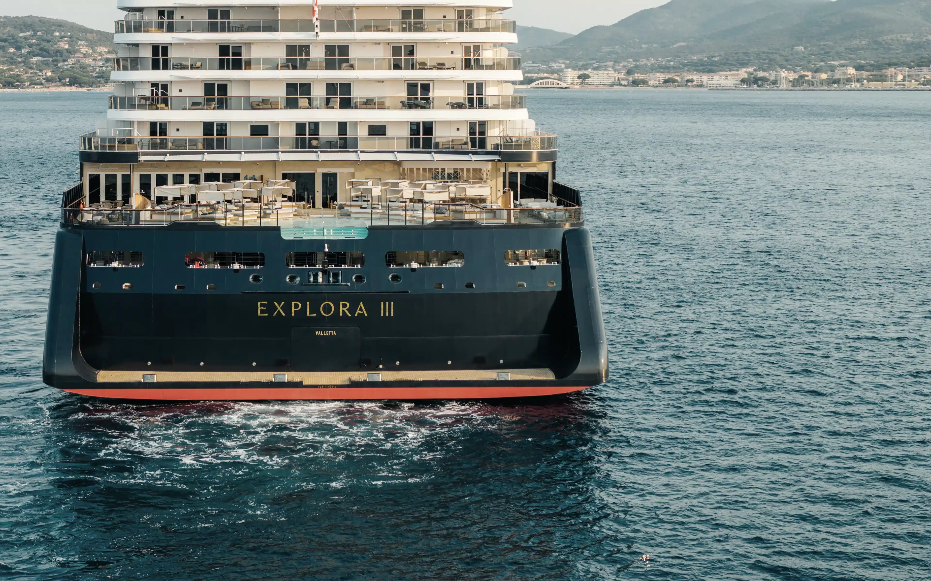 Explora III cruise ship stern view near coastline