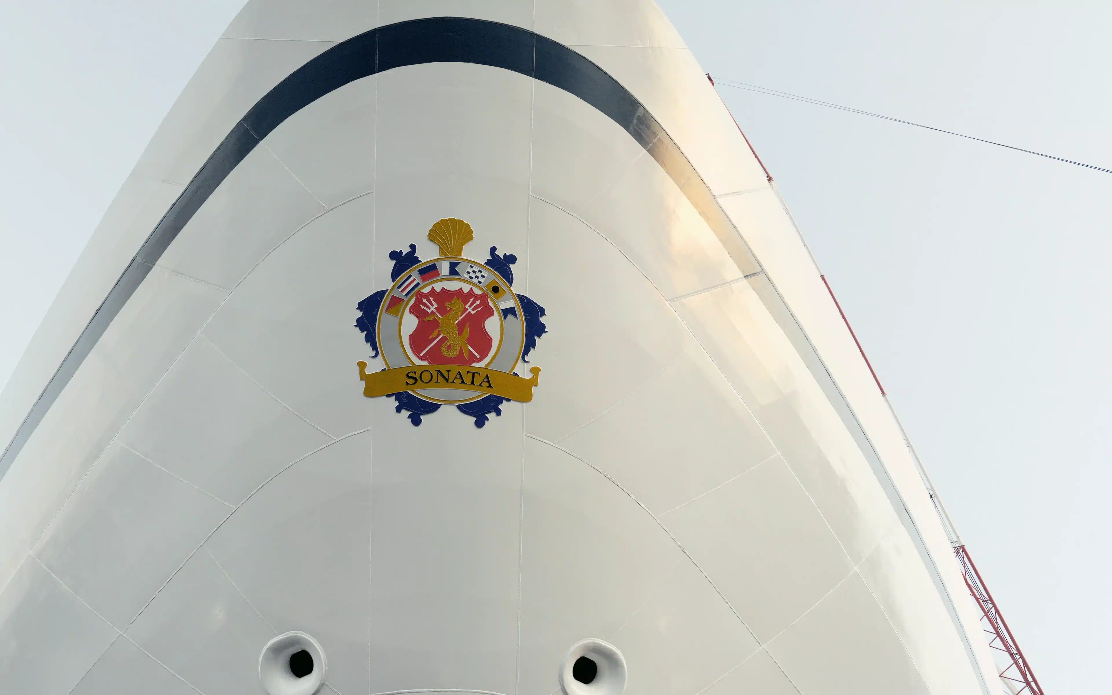 Close-up of the Oceania Sonata's gold and crimson crest