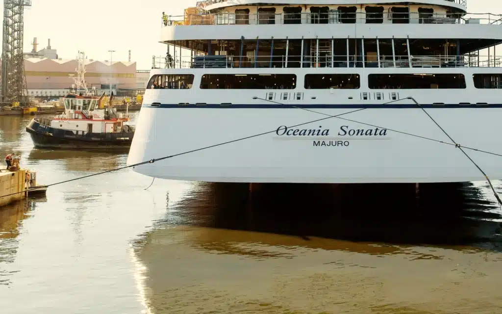 Oceania Sonata's stern reflects in the shipyard's still water