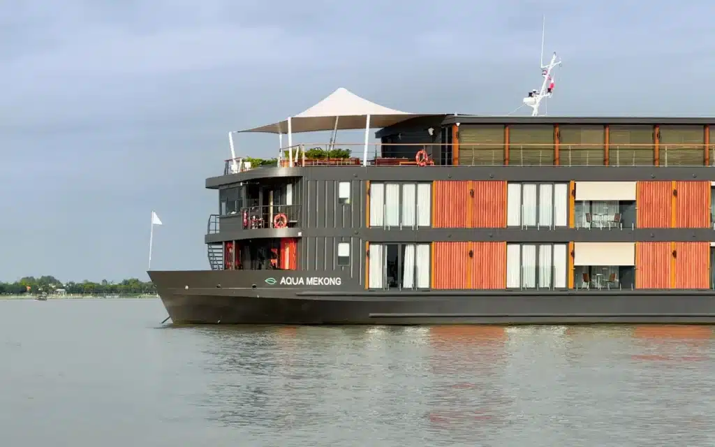 Aqua Mekong riverboat docked on the water's edge