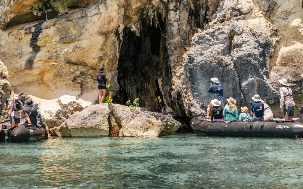 Passengers exploring a limestone sea cave from expedition tenders