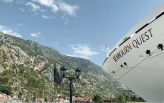 Seabourn Quest's bow moored below Kotor's mountain backdrop