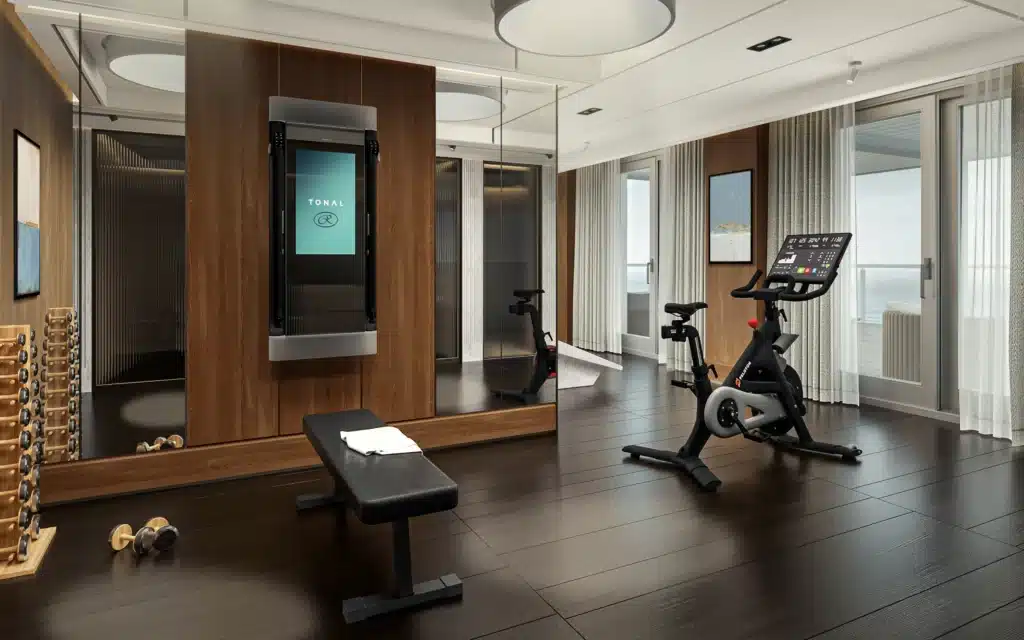 A private suite gym pairs Tonal and Peloton with ocean views
