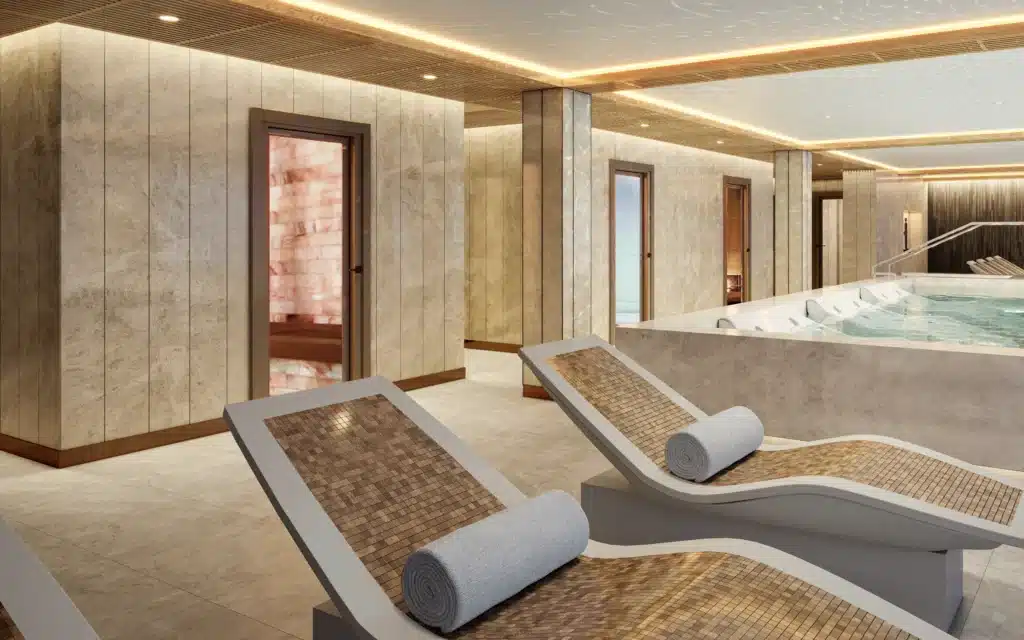 Mosaic-tiled loungers line a spa corridor near a whirlpool